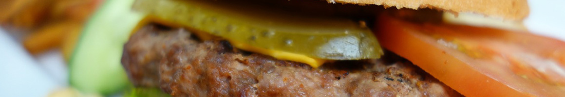 Eating Burger at Samburger Grill & Daiquiris to Go restaurant in Houston, TX.